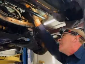 Auto tech under vehicle